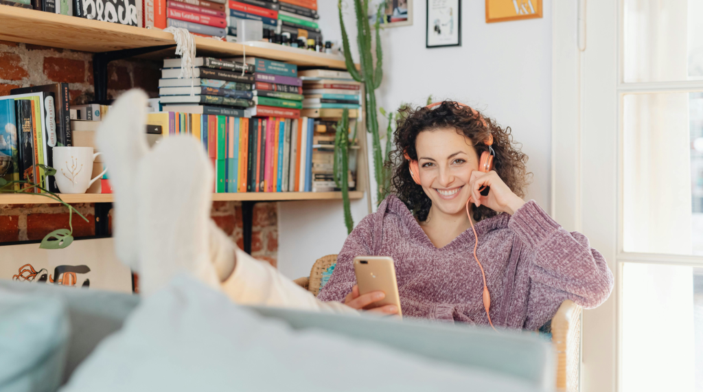 Young woman smiling while listening to music and audio books.